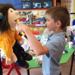 Child playing with dentist playbox